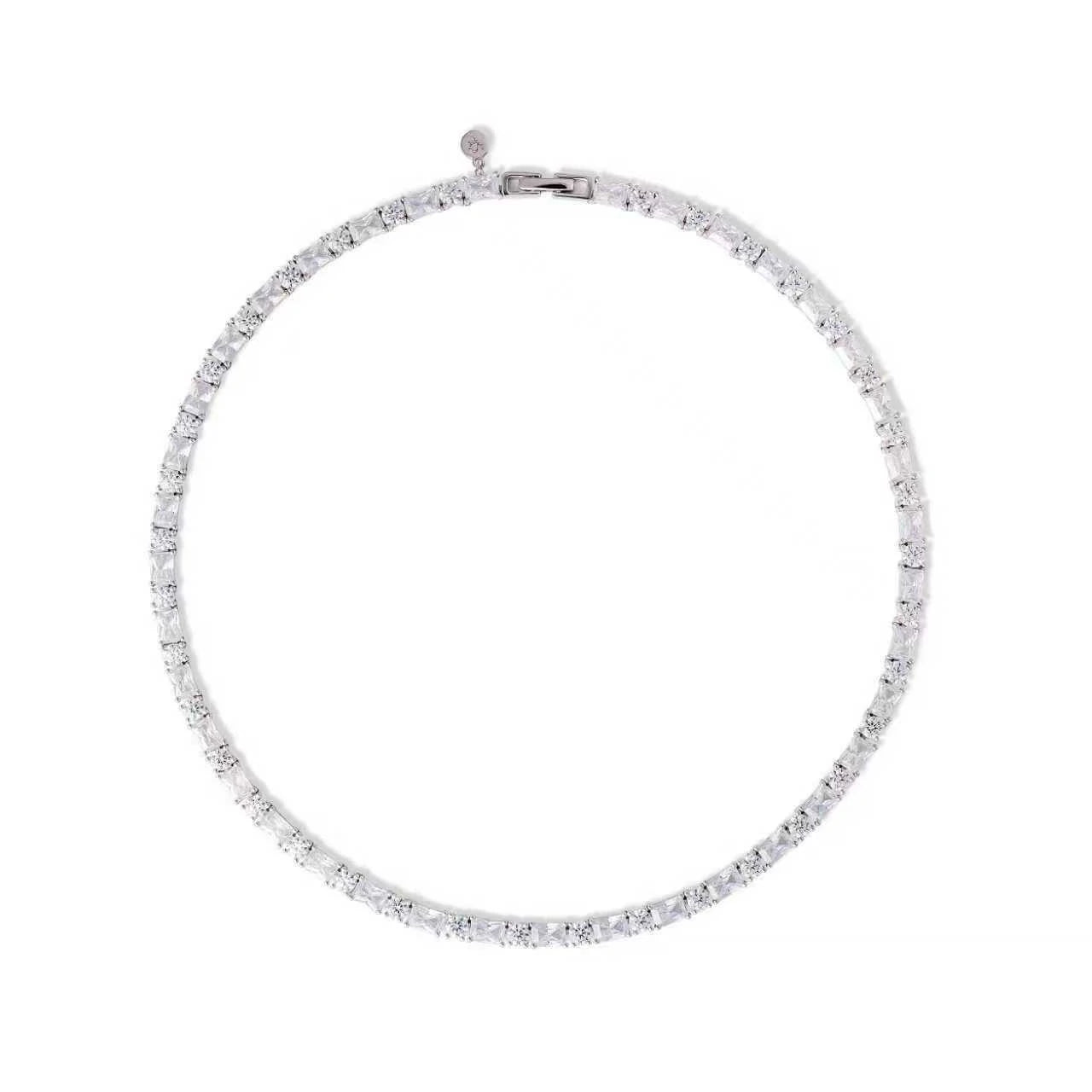 Silver necklace with clear stones on a white background
