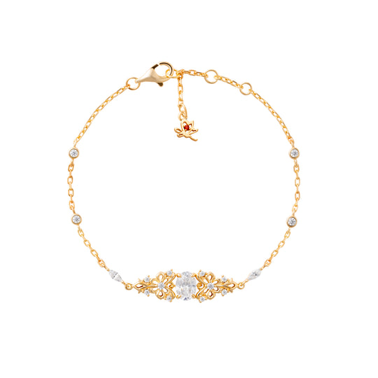 Gold bracelet with decorative clasp on a white background
