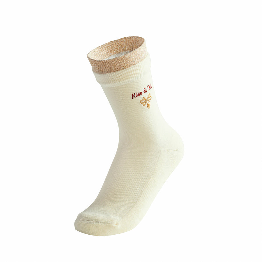 Beige sock with brown top on a white background