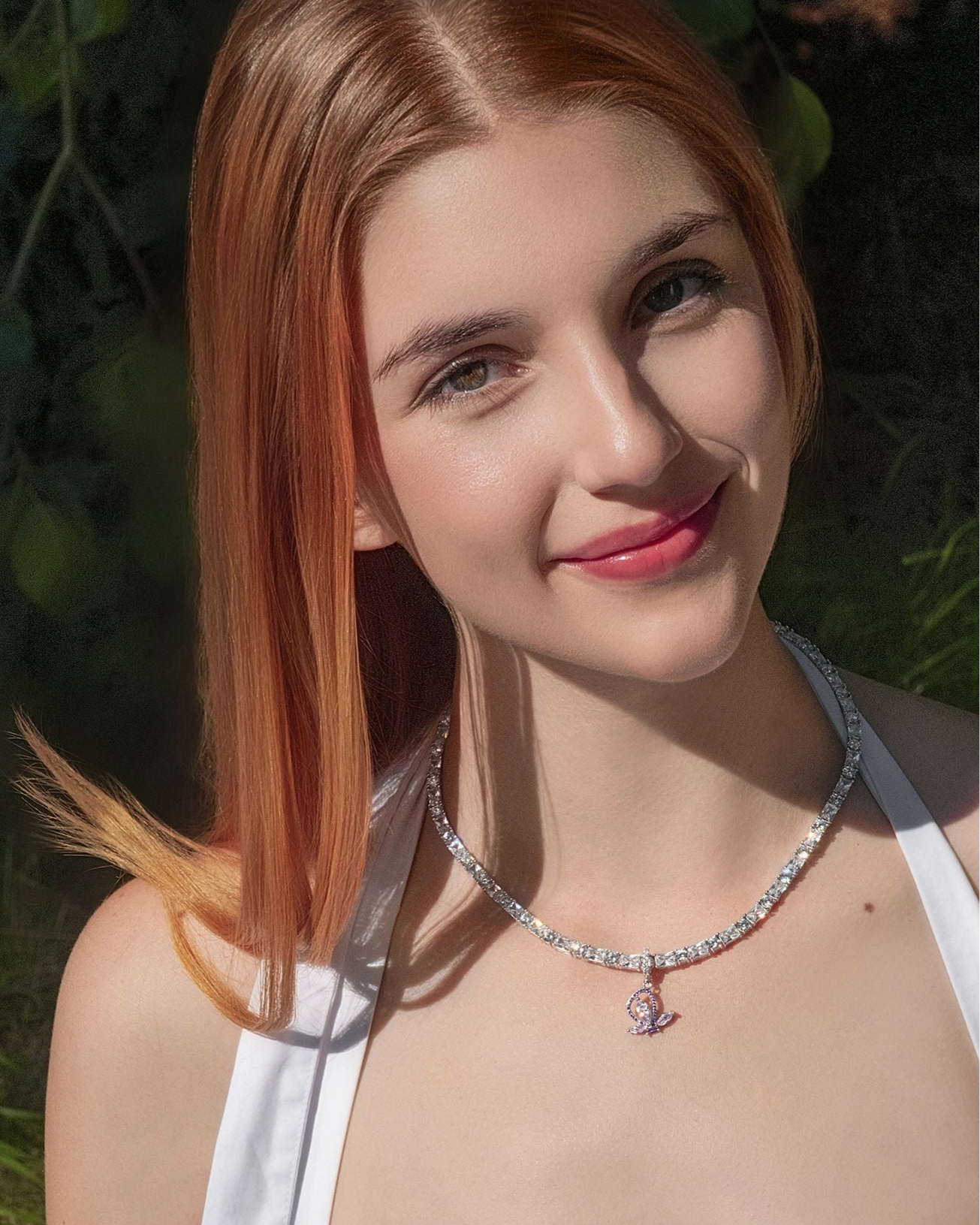 Woman with red hair wearing a necklace outdoors
