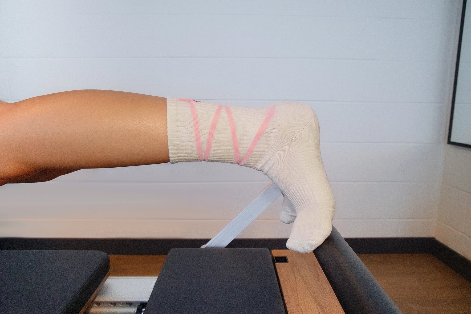 Person with a cast on their arm holding onto a railing.